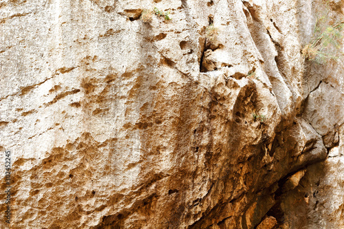 Brown red mountains shale steep cliffs near the trail, mountain trail along steep cliffs in Spain, Ardales the caminito caminito del rey. Tall red rocks mountain side in el Chorro