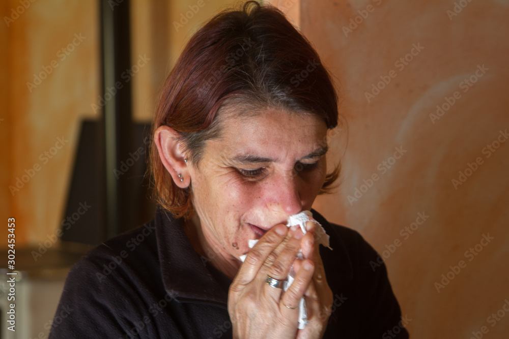 girl sneezing with a cold with a handkerchief on her nose girl sneezing with a cold with a handkerchief on her nose