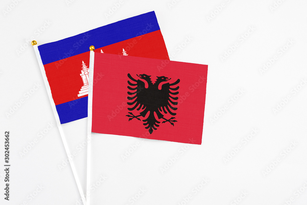 Albania and Cambodia stick flags on white background. High quality fabric, miniature national flag. Peaceful global concept.White floor for copy space. Albania and Cambodia stick flags on white background. High quality fabric, miniature national flag. Peaceful global concept.White floor for copy space.