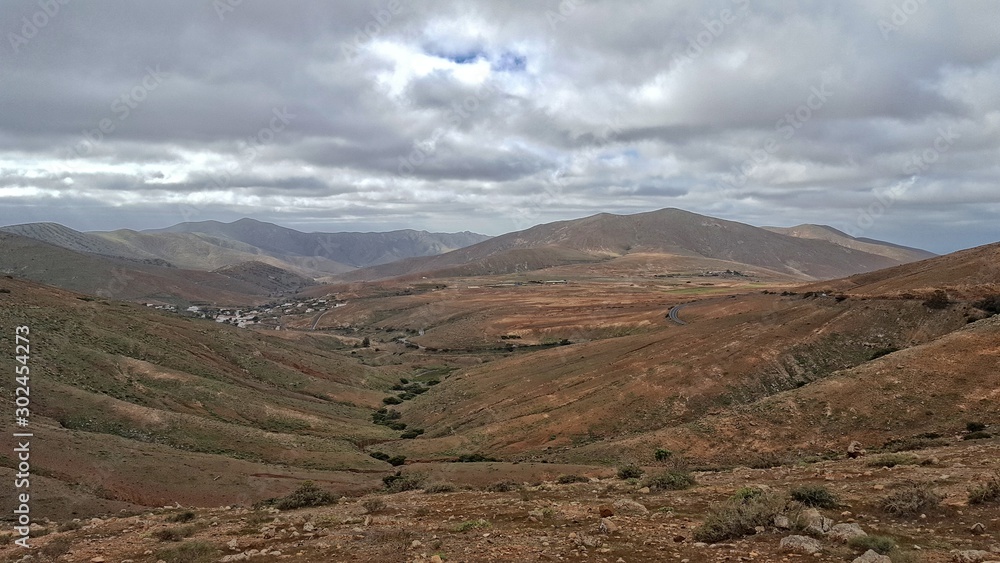  empty mysterious mountainous landscape from the center of the Canary Island Spanish Fuerteventura with a cloudy sky