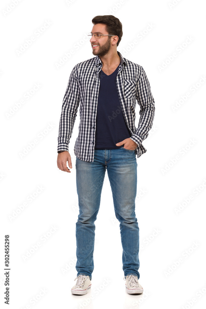 Casual Man In Eyeglasses Is Standing With Hand In Pocket And Looking Away Casual Man In Eyeglasses Is Standing With Hand In Pocket And Looking Away