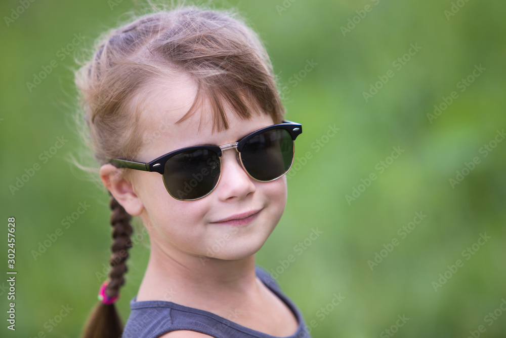 Portrait of pretty child girl with braids in hair outdoors in summer. Portrait of pretty child girl with braids in hair outdoors in summer.
