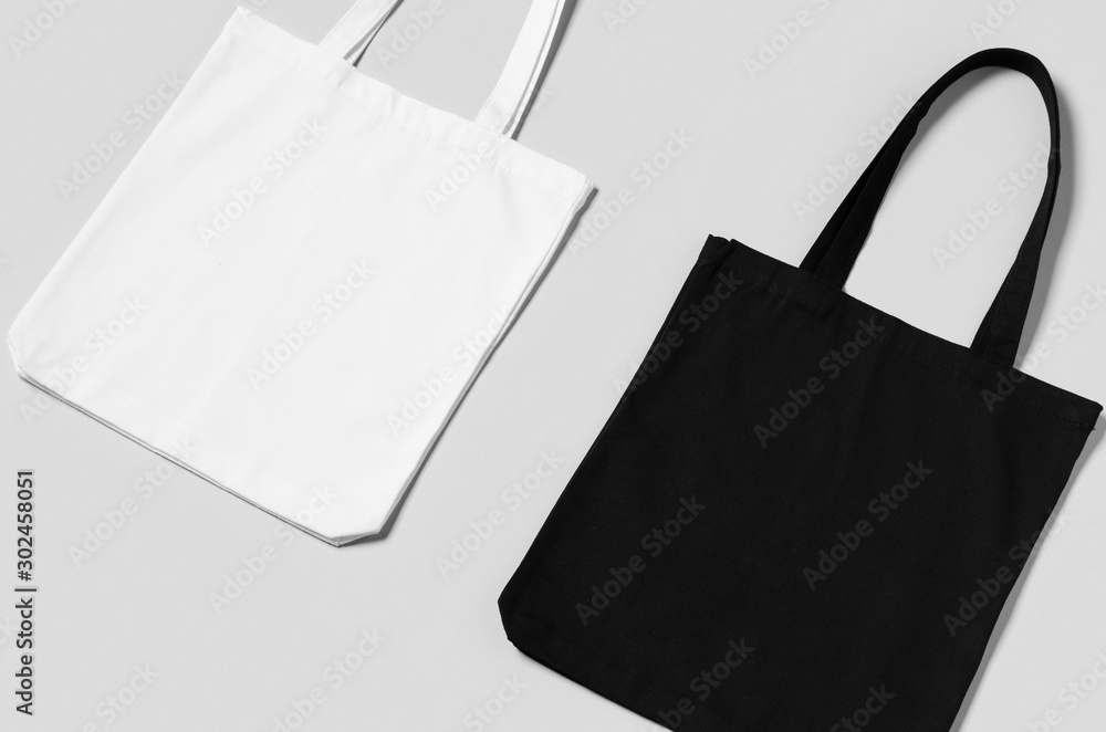 White and black tote bags mockup on a grey background. Stock Photo ...