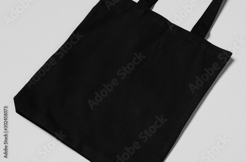 Black tote bag mockup on a grey background. photo