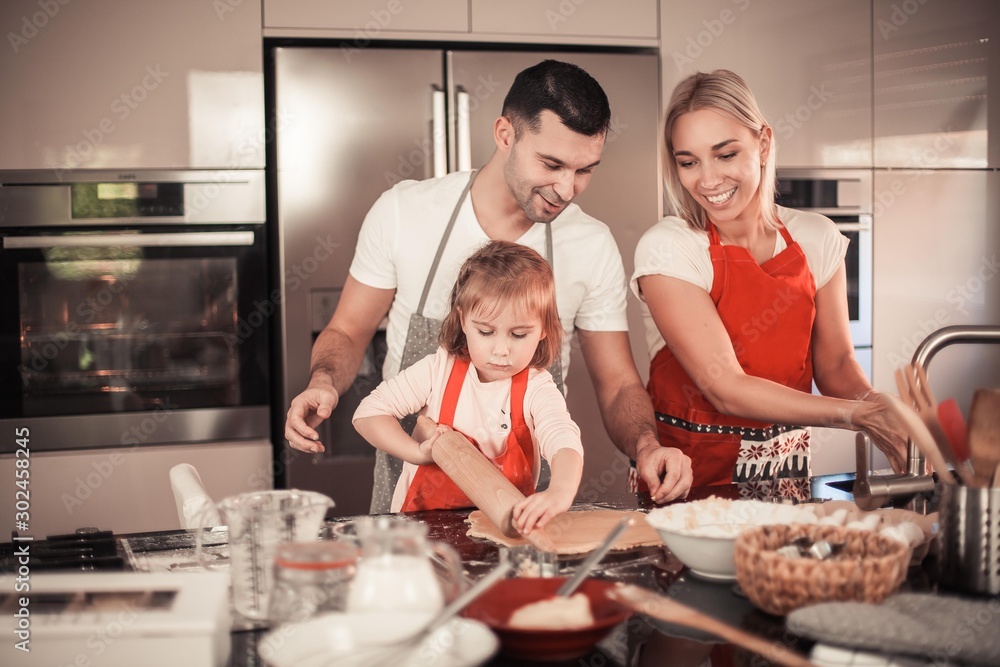 Beautiful family bake christmas cookies. Family cooks in the kitchen. Holidays. Christmas. New Year. Cozy. Beautiful family bake christmas cookies. Family cooks in the kitchen. Holidays. Christmas. New Year. Cozy.
