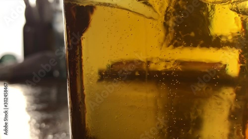 A rack focus of bubbles rising within an American draft beer. Shot in 24fps HD. photo