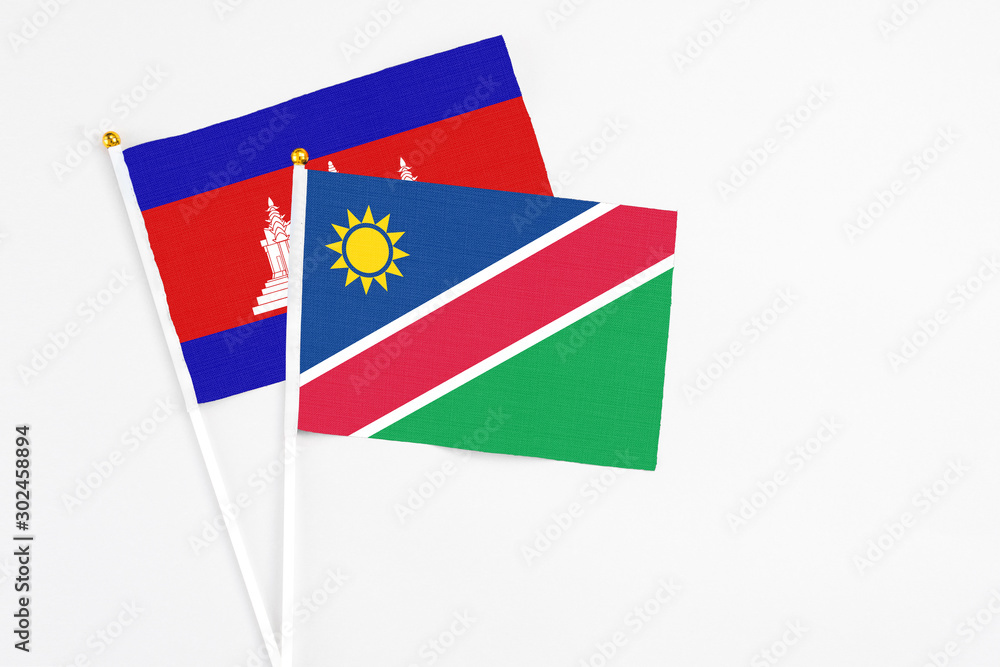Namibia and Cambodia stick flags on white background. High quality fabric, miniature national flag. Peaceful global concept.White floor for copy space. Namibia and Cambodia stick flags on white background. High quality fabric, miniature national flag. Peaceful global concept.White floor for copy space.