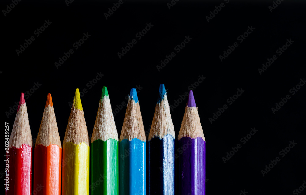 Coloured pencils isolated on black background close up. Vintage look Macro photography. Pencils Wallpaper. Bundle of rainbow colored pencils with selected focus on tips. Multicolored rainbow pencils. Coloured pencils isolated on black background close up. Vintage look Macro photography. Pencils Wallpaper. Bundle of rainbow colored pencils with selected focus on tips. Multicolored rainbow pencils.