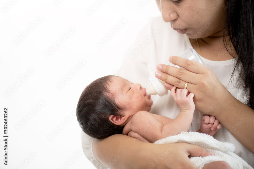 New born infant on white cloth and carrying by her mother while laying on her shoulder. Mother Love Concept New born infant on white cloth and carrying by her mother while laying on her shoulder. Mother Love Concept