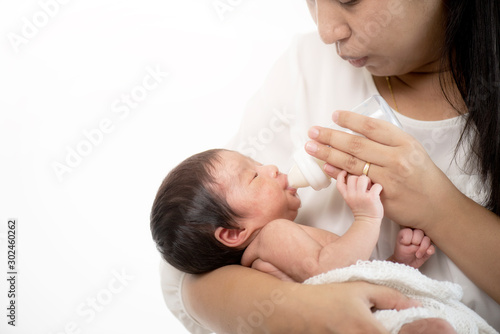 New born infant on white cloth and carrying by her mother while laying on her shoulder. Mother Love Concept 