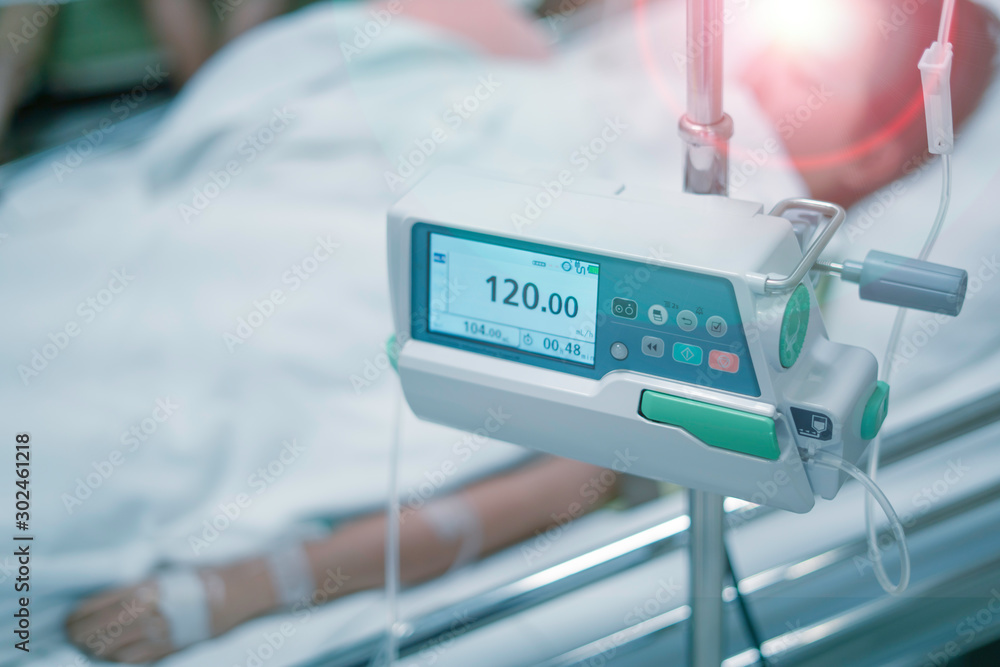 Infusion pumps with blurry patient in hospital. with blurry patient in hospital.