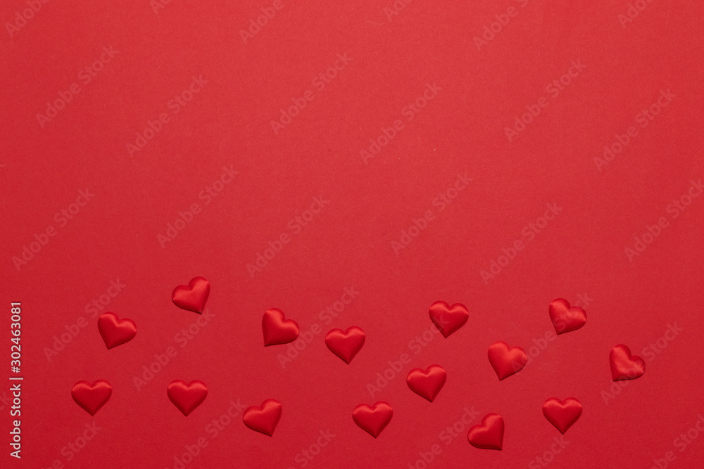 Flat lay greeting card with many red heart shapes on a red background with copyspace. Valentine day composition
