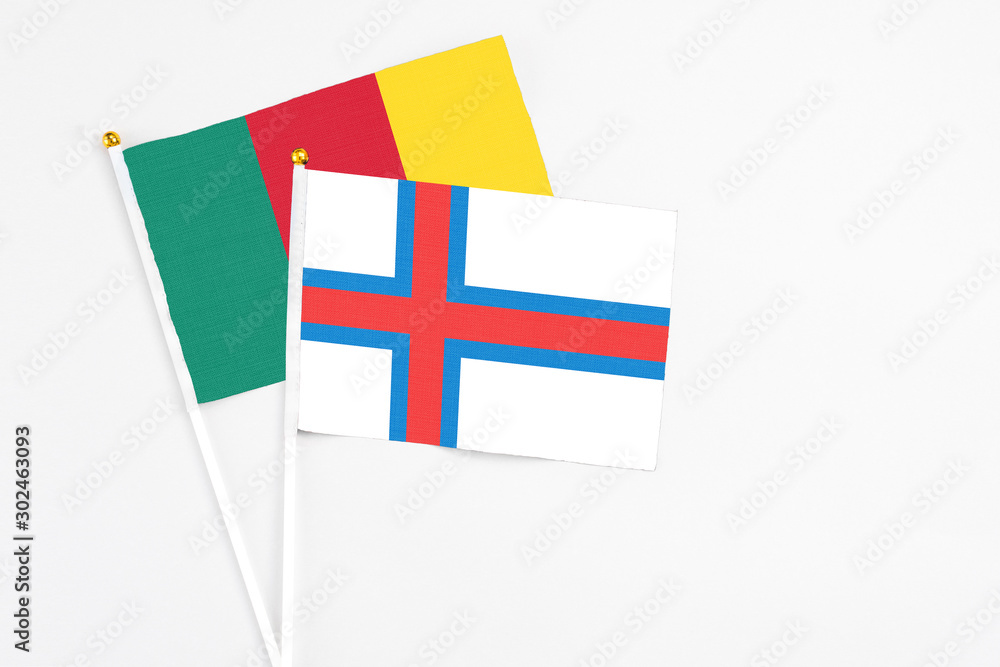 Faroe Islands and Cameroon stick flags on white background. High quality fabric, miniature national flag. Peaceful global concept.White floor for copy space. Faroe Islands and Cameroon stick flags on white background. High quality fabric, miniature national flag. Peaceful global concept.White floor for copy space.