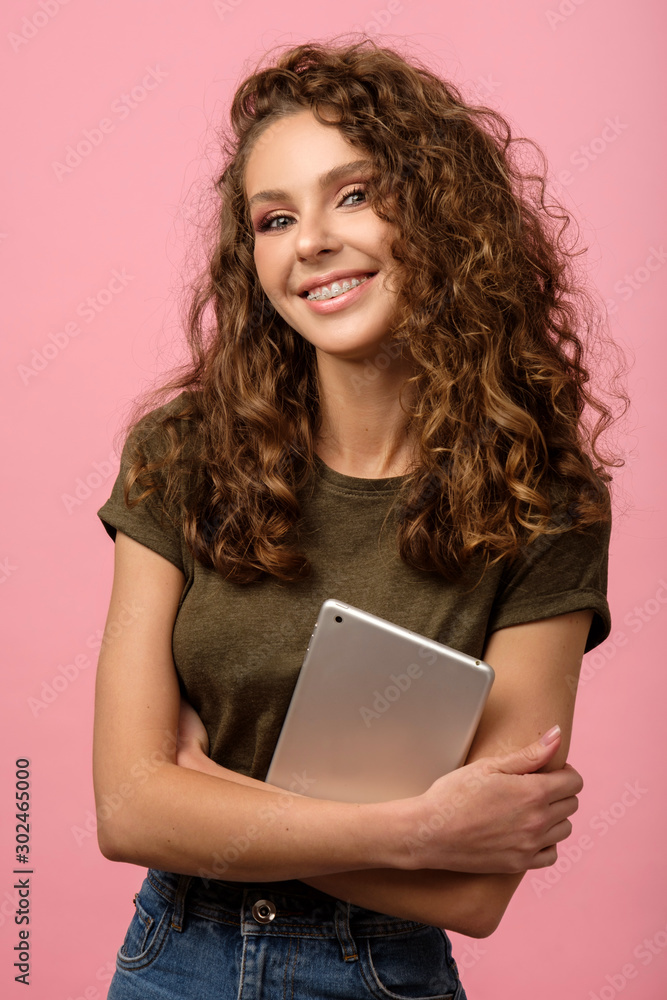 Pretty girl with tablet on pink background Pretty girl with tablet on pink background