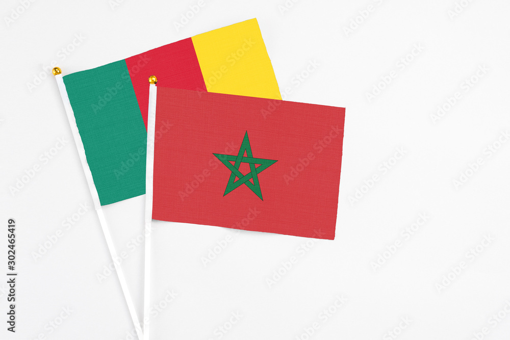 Morocco and Cameroon stick flags on white background. High quality fabric, miniature national flag. Peaceful global concept.White floor for copy space. Morocco and Cameroon stick flags on white background. High quality fabric, miniature national flag. Peaceful global concept.White floor for copy space.