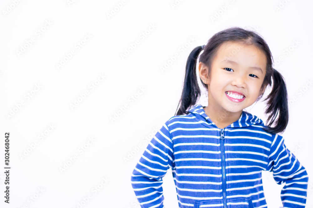 A little girl with a smiling face, aged three and a half wearing a blue sweate A little girl with a smiling face, aged three and a half wearing a blue sweate