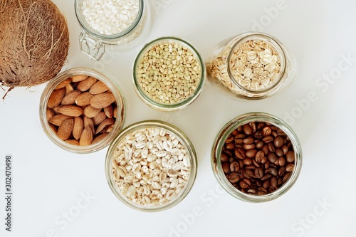 Various raw cereals, grains in glass jars. The concept of zero waste, food storage in the kitchen, healthy nutrition. View from above.