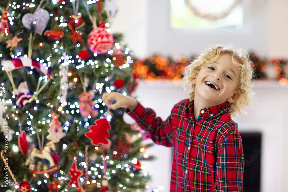 Child decorating Christmas tree. Kid on Xmas eve. Child decorating Christmas tree. Kid on Xmas eve.