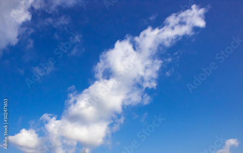 Sunny sky abstract background, beautiful cloudscape, on the heaven, view over white fluffy clouds, freedom concept.
