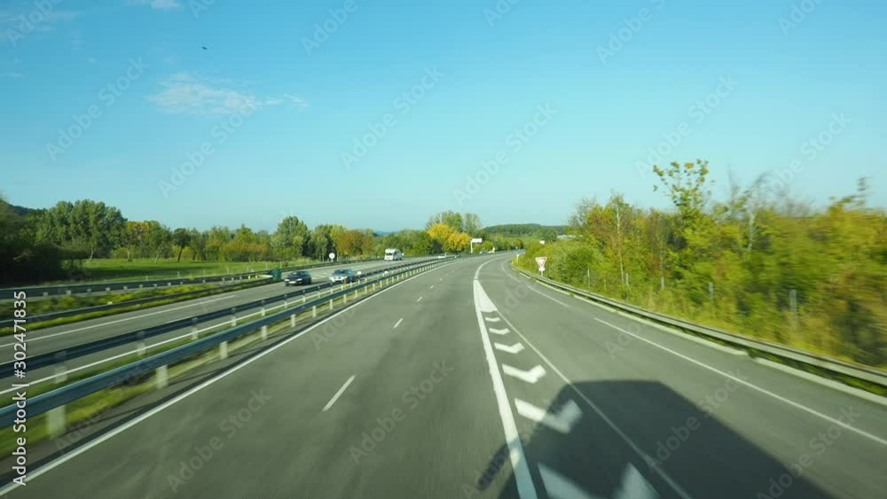 Bus driver point of view. Driving on straight road passing by highway entrance in sunny day. Bus driver point of view. Driving on straight road passing by highway entrance in sunny day.