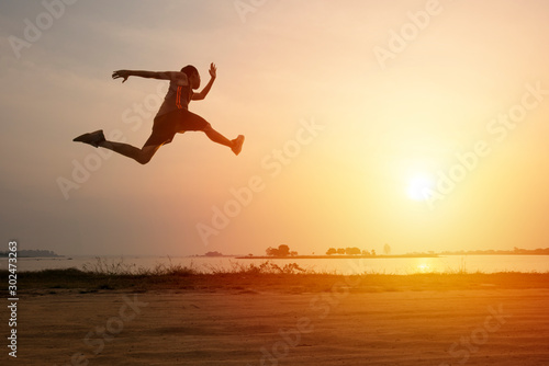 Athlete runner on road with sunset or sunrise   sport and healthy concept