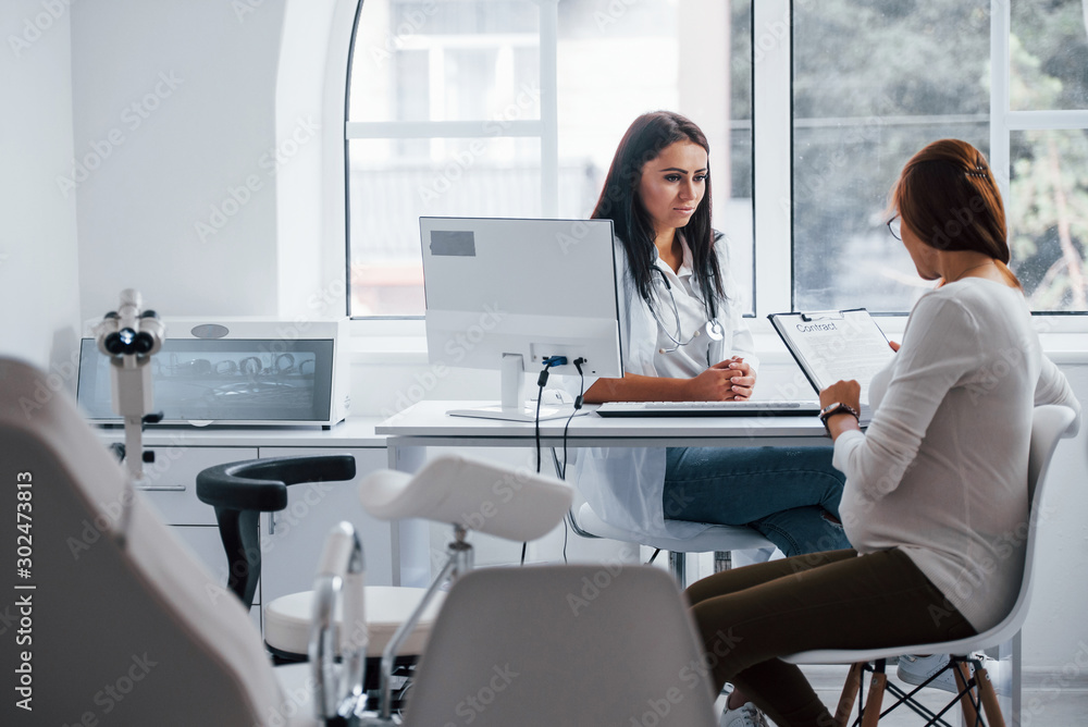 Active conversation. Pregnant woman have consultation with obstetrician indoors Active conversation. Pregnant woman have consultation with obstetrician indoors