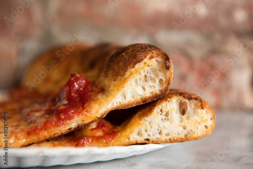 Side view of two slices of pizza and crust