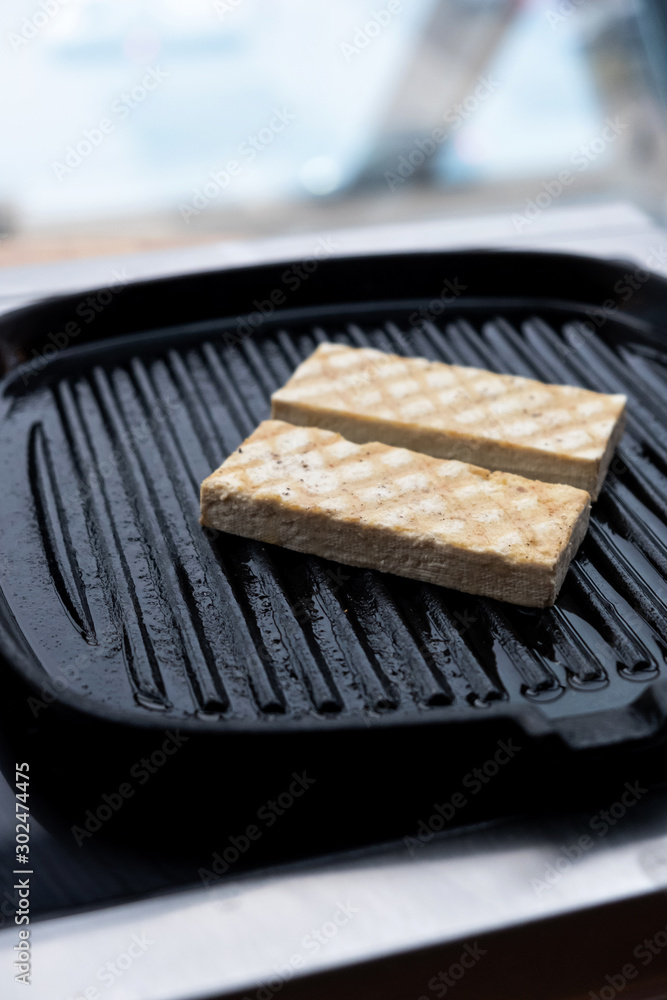 Baked marinated tofu with herbs and spices. Chef cooking. Healthy food concept. Baked marinated tofu with herbs and spices. Chef cooking. Healthy food concept.