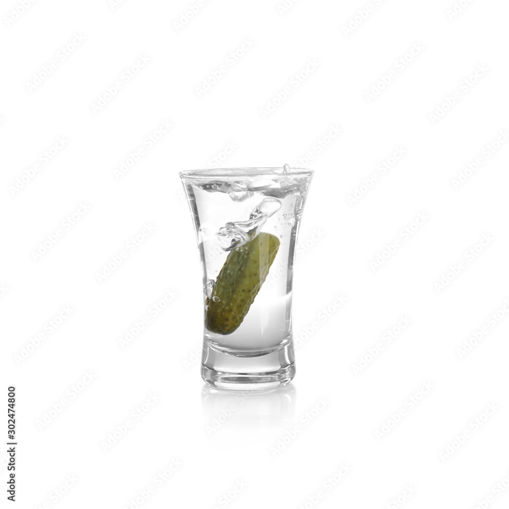 Russian vodka with pickle in shot glass isolated on white Russian vodka with pickle in shot glass isolated on white