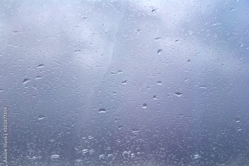 drops of rain on glass window blurred forest background drops of rain on glass window blurred forest background