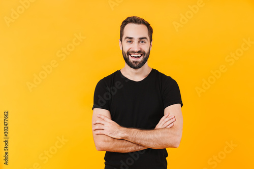 Image of happy man wearing basic black t-shirt smiling at camera