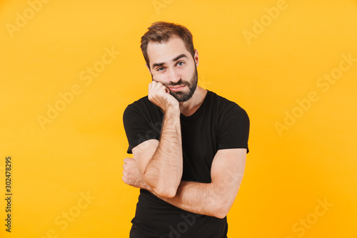 Image of caucasian man in t-shirt propping up his head in boredom