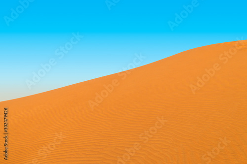 Big Desert Sand Dune with Blue Sky Background