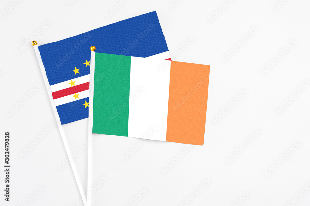 Ireland and Cape Verde stick flags on white background. High quality fabric, miniature national flag. Peaceful global concept.White floor for copy space. Ireland and Cape Verde stick flags on white background. High quality fabric, miniature national flag. Peaceful global concept.White floor for copy space.