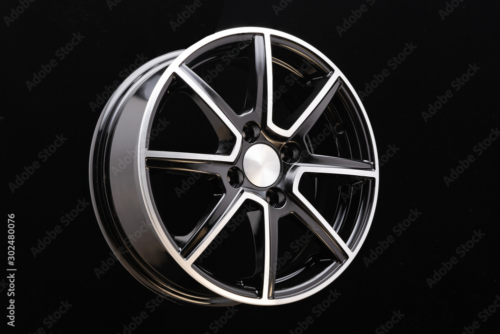 Obraz premium Alloy rim on black background, alloy wheels closeup. The elements spokes