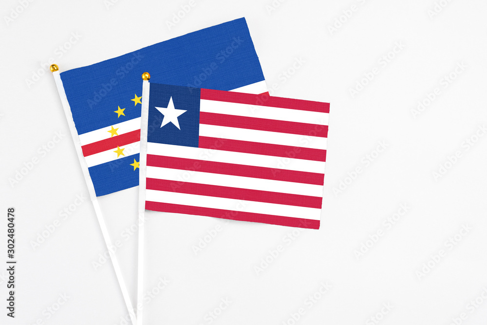 Liberia and Cape Verde stick flags on white background. High quality fabric, miniature national flag. Peaceful global concept.White floor for copy space. Liberia and Cape Verde stick flags on white background. High quality fabric, miniature national flag. Peaceful global concept.White floor for copy space.