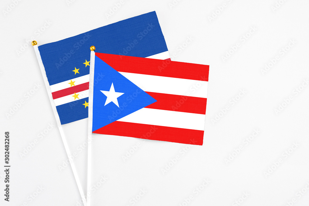 Puerto Rico and Cape Verde stick flags on white background. High quality fabric, miniature national flag. Peaceful global concept.White floor for copy space. Puerto Rico and Cape Verde stick flags on white background. High quality fabric, miniature national flag. Peaceful global concept.White floor for copy space.