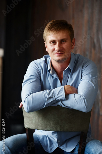 Portrait of man in official shirt that posing for the camera indoors