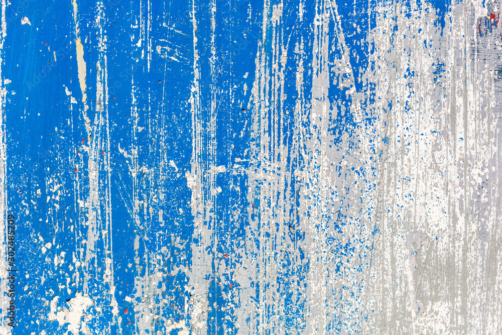 Fototapeta premium Blue and white texture grunge background. Surface covered with peeling paint, stains, scratches, stripes