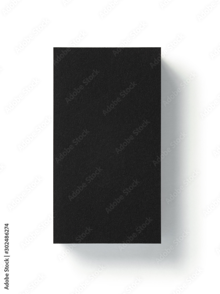 Blank black business card isolated on white background. Top view. Standard size. Stylish textured stack of cardboard for personal advertising or corporate design. 