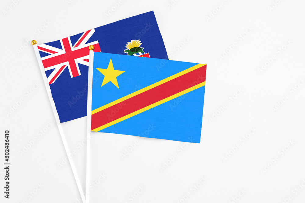 Congo and Cayman Islands stick flags on white background. High quality fabric, miniature national flag. Peaceful global concept.White floor for copy space. Congo and Cayman Islands stick flags on white background. High quality fabric, miniature national flag. Peaceful global concept.White floor for copy space.