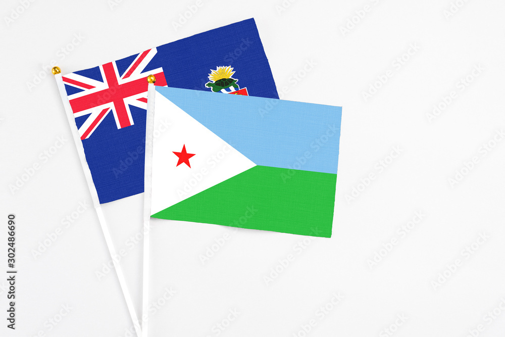 Djibouti and Cayman Islands stick flags on white background. High quality fabric, miniature national flag. Peaceful global concept.White floor for copy space. Djibouti and Cayman Islands stick flags on white background. High quality fabric, miniature national flag. Peaceful global concept.White floor for copy space.