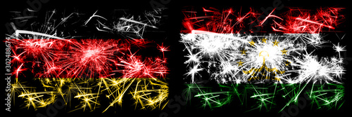 Germany, German vs Tajikistan, Tajikistani New Year celebration travel sparkling fireworks flags concept background. Combination of two abstract states flags.