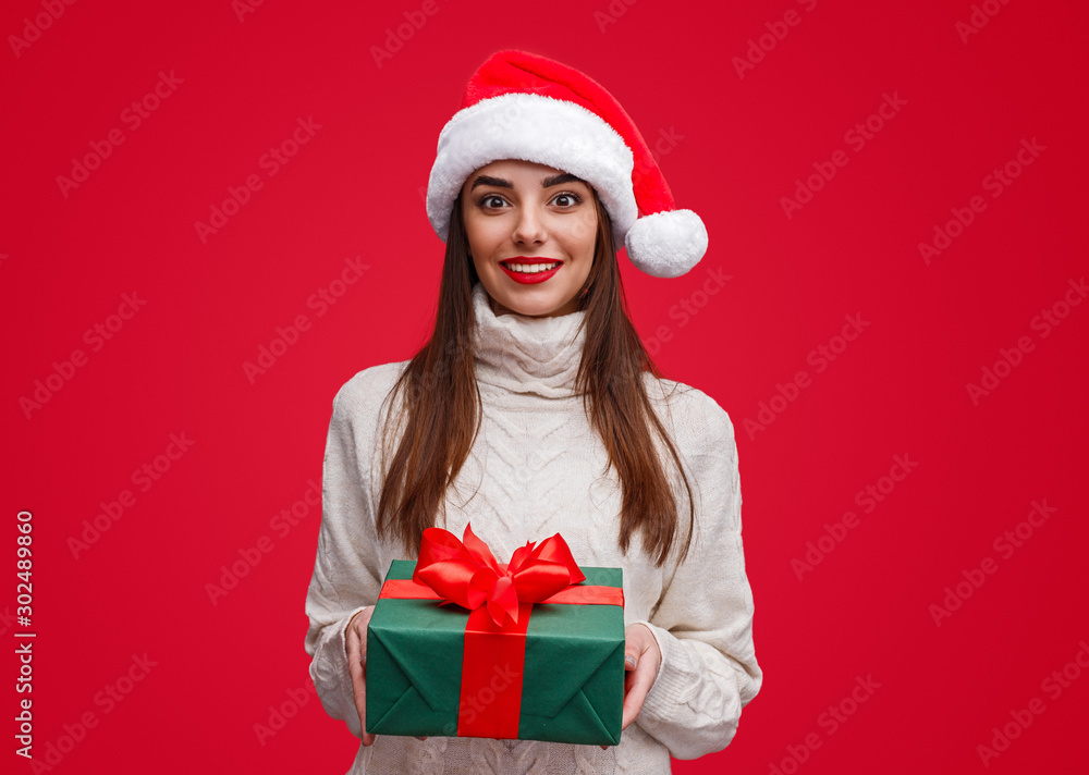 Young woman giving Christmas present Young woman giving Christmas present