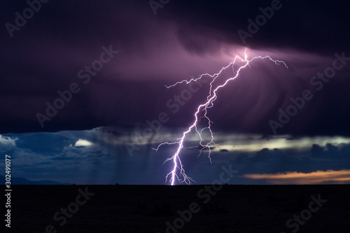 Lightning and storm clouds at sunset