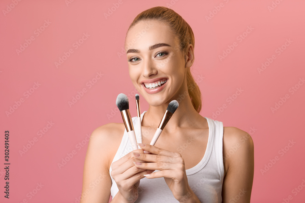 Beauty portrait of woman holding make-up brushes Beauty portrait of woman holding make-up brushes