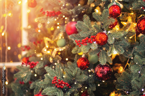 Christmas background banner pine tree branch with decorations red balls star, with bokeh light