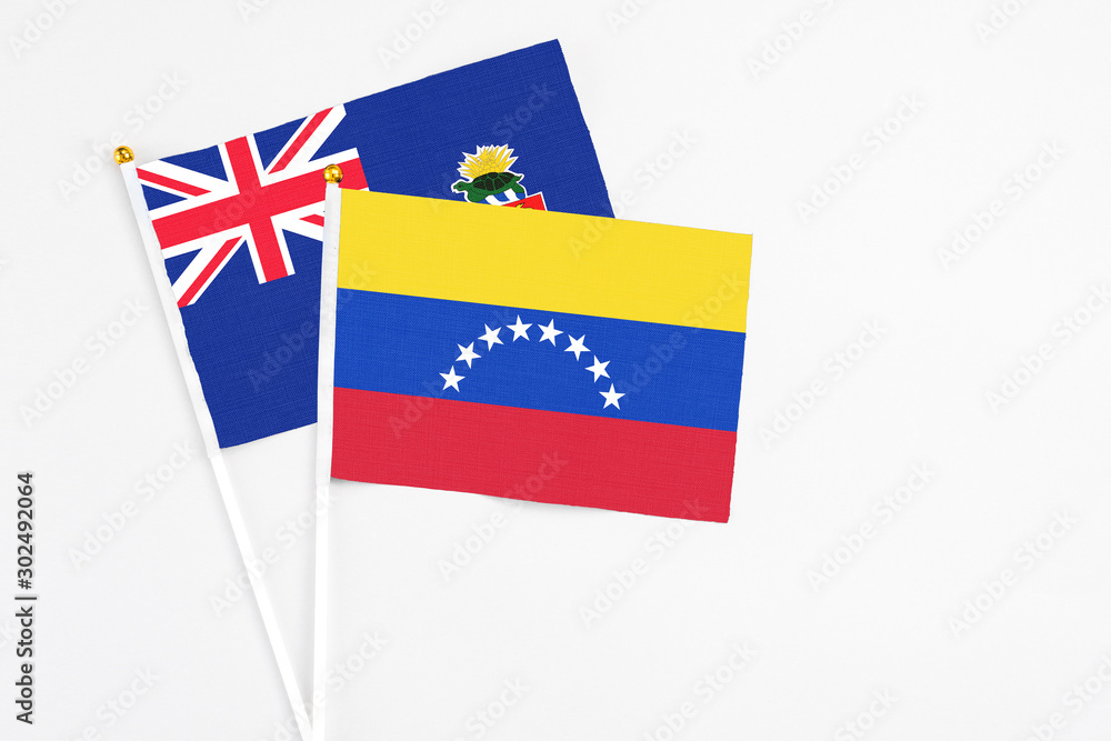 Venezuela and Cayman Islands stick flags on white background. High quality fabric, miniature national flag. Peaceful global concept.White floor for copy space. Venezuela and Cayman Islands stick flags on white background. High quality fabric, miniature national flag. Peaceful global concept.White floor for copy space.