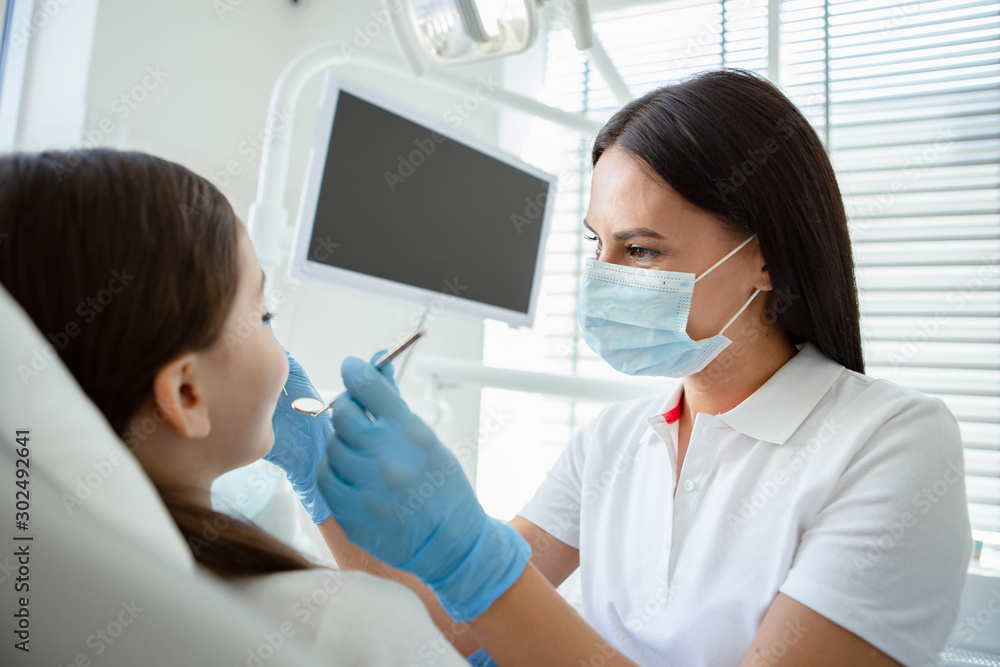 side view of Doctor treating small patient teeth in modern dental clinic side view of Doctor treating small patient teeth in modern dental clinic