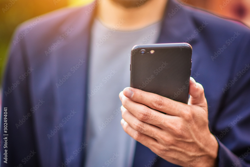 Businessman holding cell phone using Mobile phone or Smart phone Telephone to call phone with Social media Icon technology by WiFi internet Businessman holding cell phone using Mobile phone or Smart phone Telephone to call phone with Social media Icon technology by WiFi internet